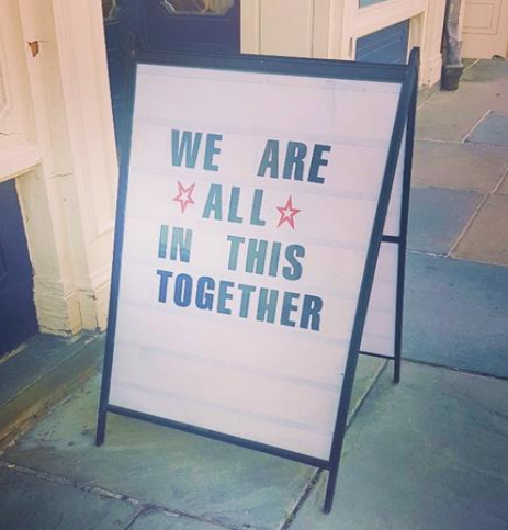 we are all in this together sign in new york city - corporate social responsibility